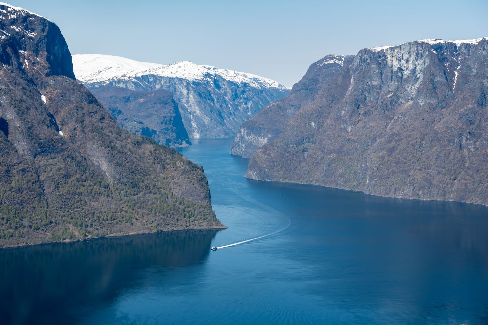 Deep blue Aurlandsfjord between snow-capped mountains, scenery on the best Norwegian fjords cruise routes