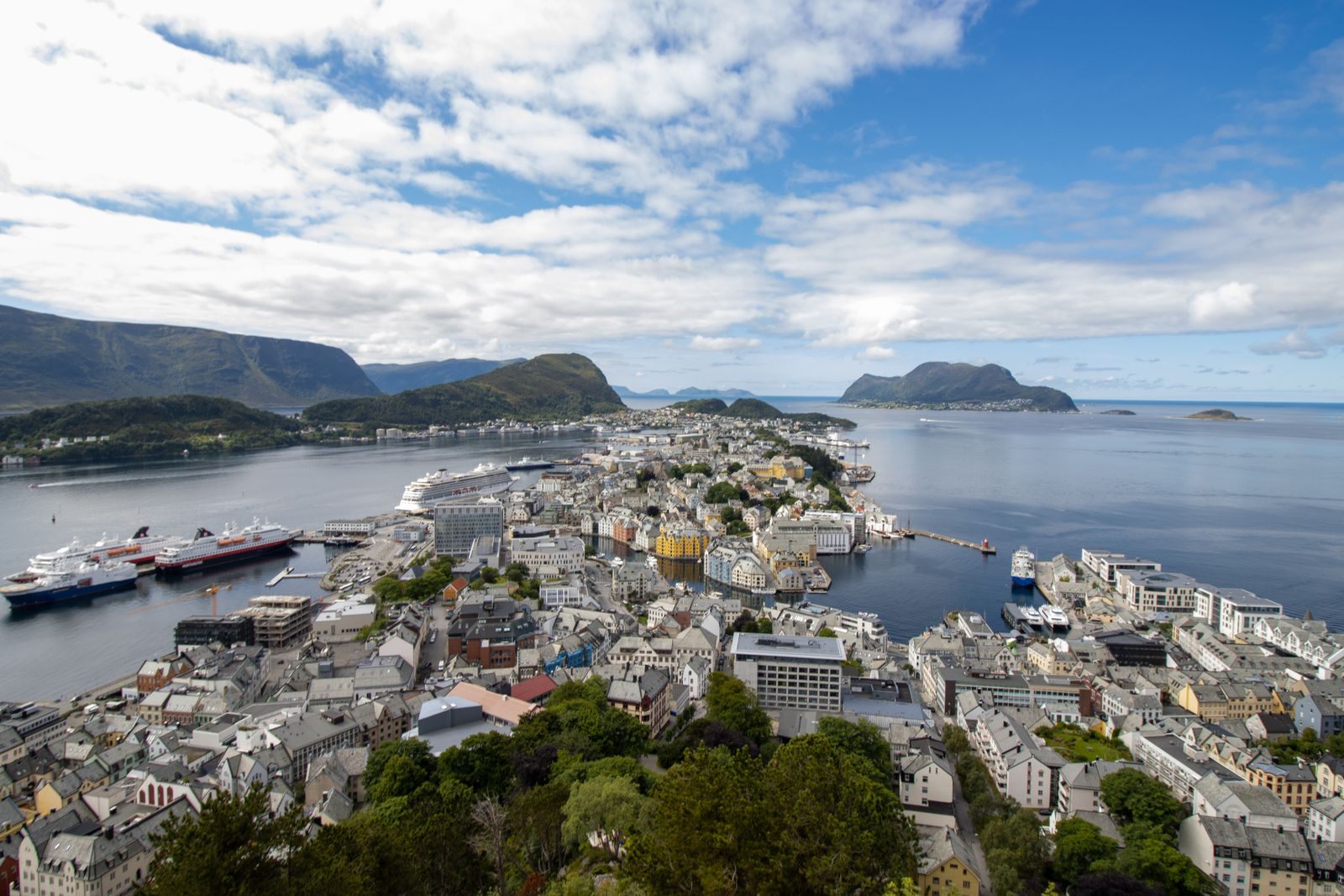 Aerial view of Alesund on its islands with a cruise ship at the quay, a typical call on a Norwegian fjords cruise from Southampton